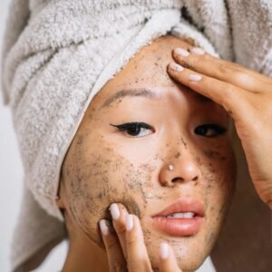 Using a gentle face and body scrub to remove dead skin cells for a smooth summer glow