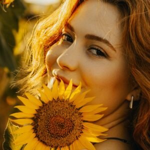 A woman with radiant and glowing skin showcasing the results of a natural summer skincare routine