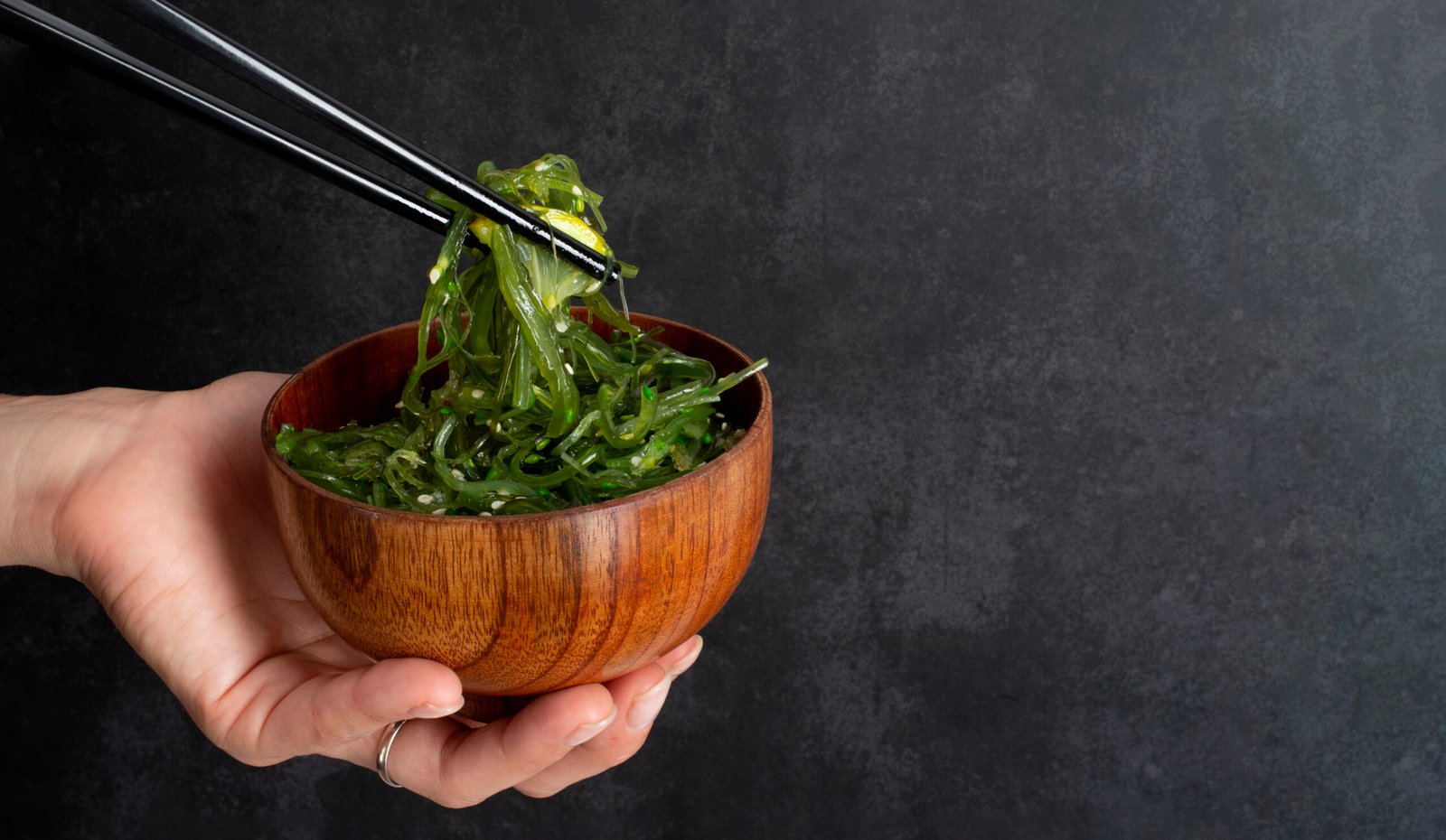 Healthy spirulina seaweed meal in wooden bowl showing natural way to take spirulina
