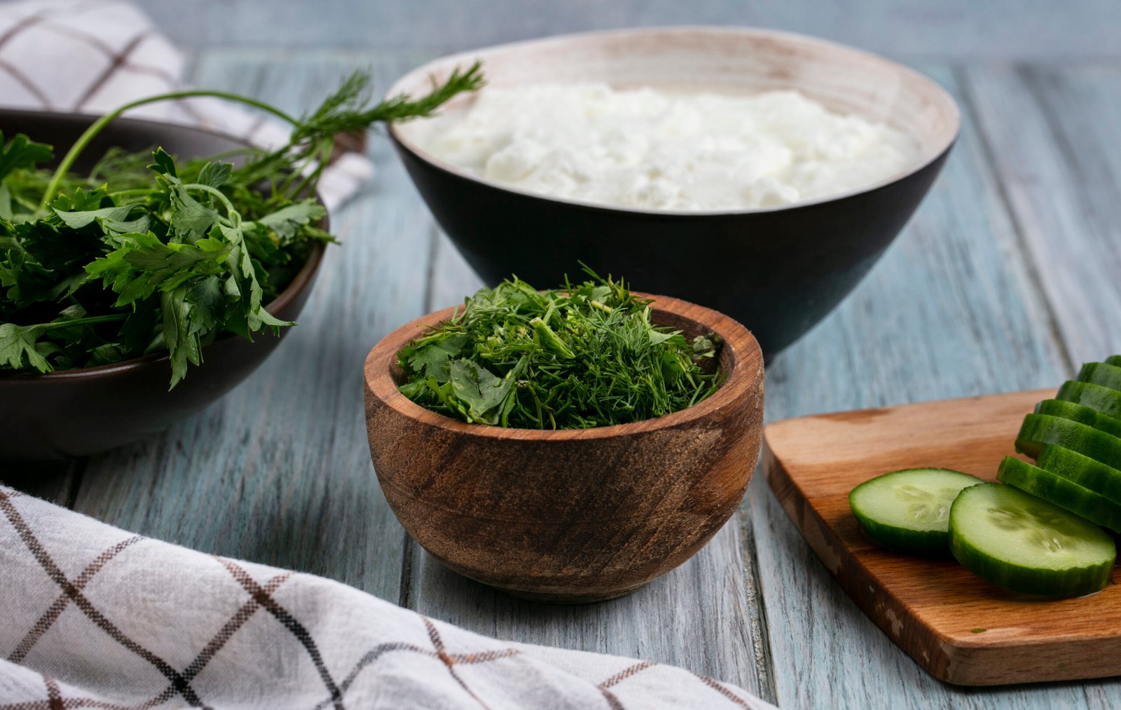 Spirulina yogurt bowl with cucumber slices and fresh green herbs for healthy detox nutrition