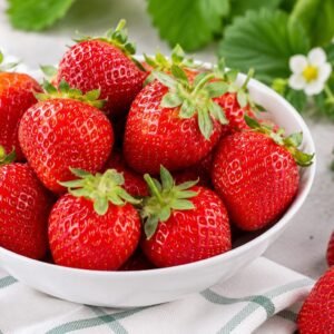 Fresh whole strawberries arranged beautifully on a premium plate, one of the Best Vitamin C Fruits for Glowing Skin.